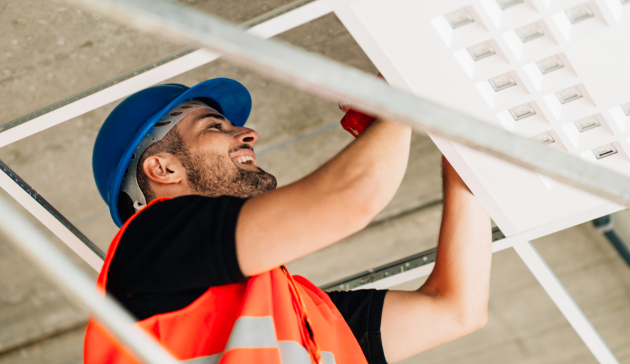 maintenance man fixing a duct in the ceiling