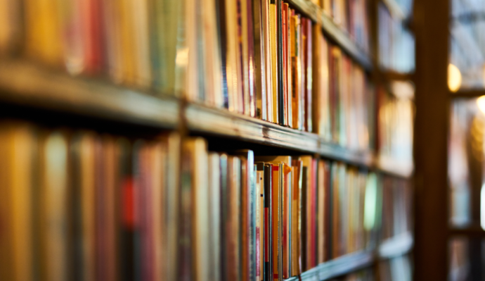 Close up of colourful books on library shelves