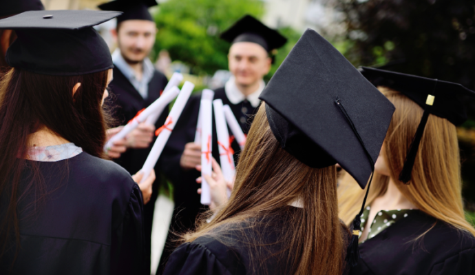 Group of graduates celebrating with their degree certificates